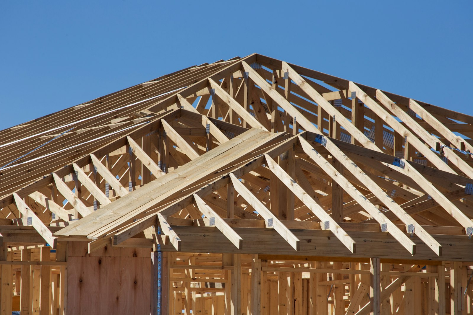 Timber roof trusses on a new home before a complete new roof installation